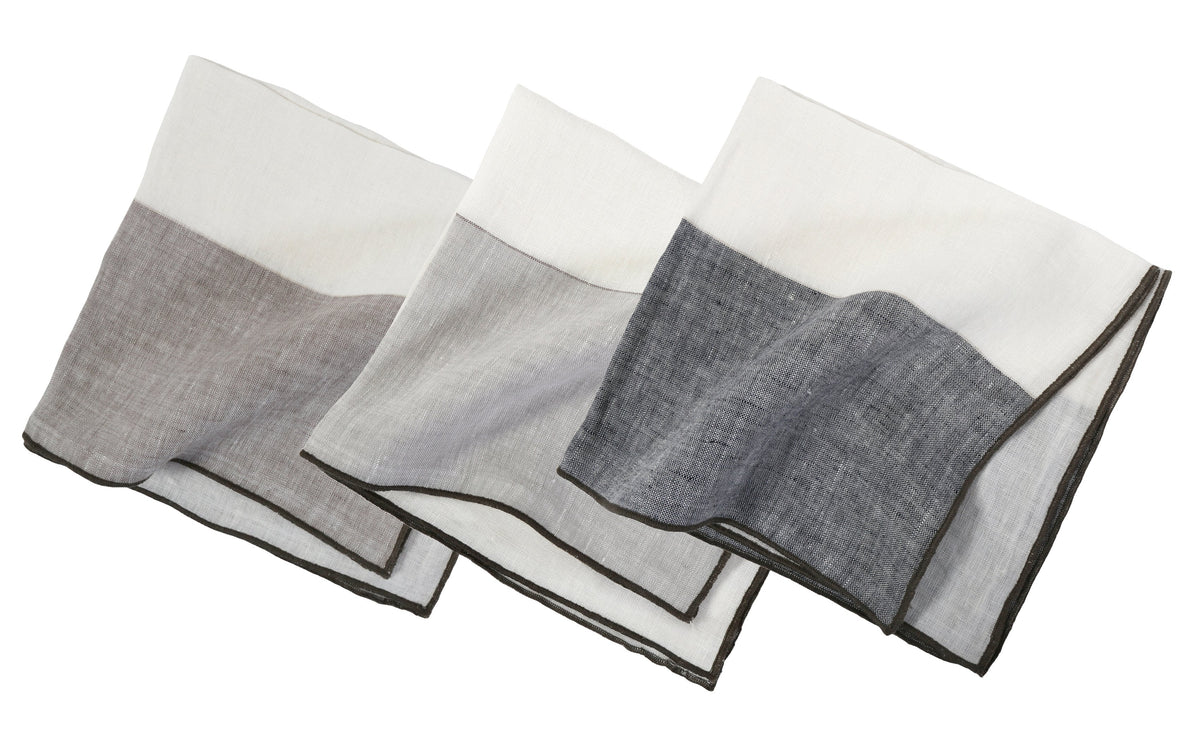 Stack of two-tone napkins in white and gray with dark stitched border edges