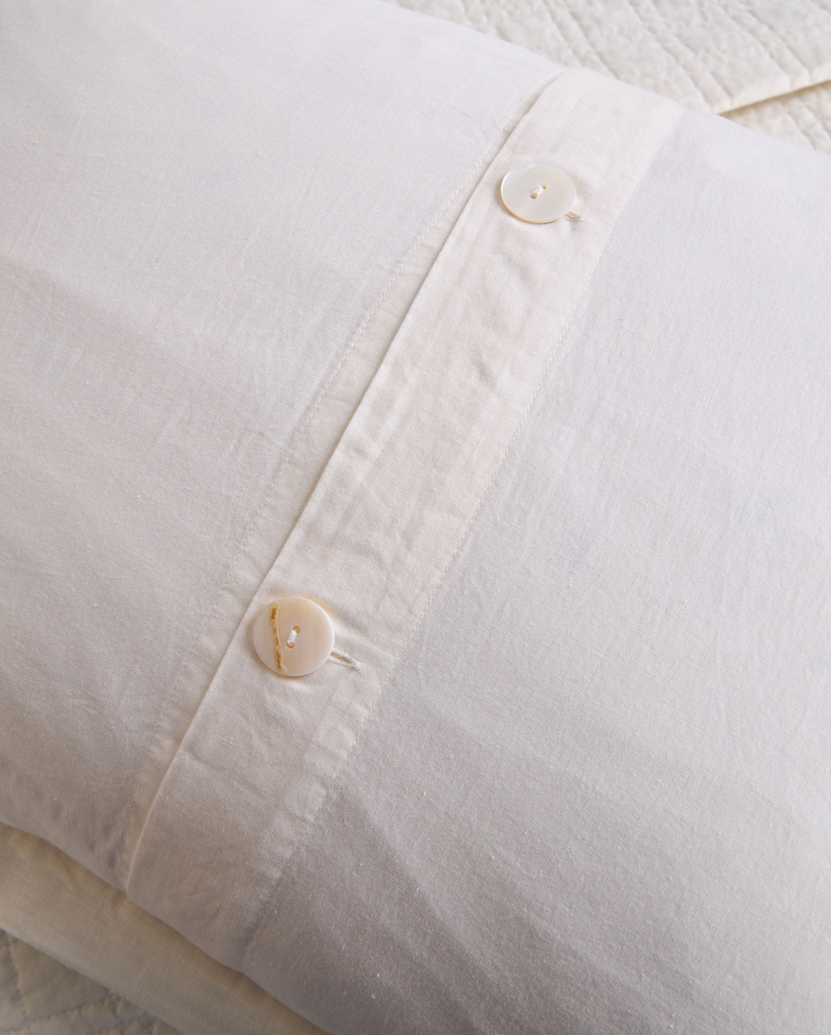Owen coverlet sham in white with button closure detail and fine textured weave