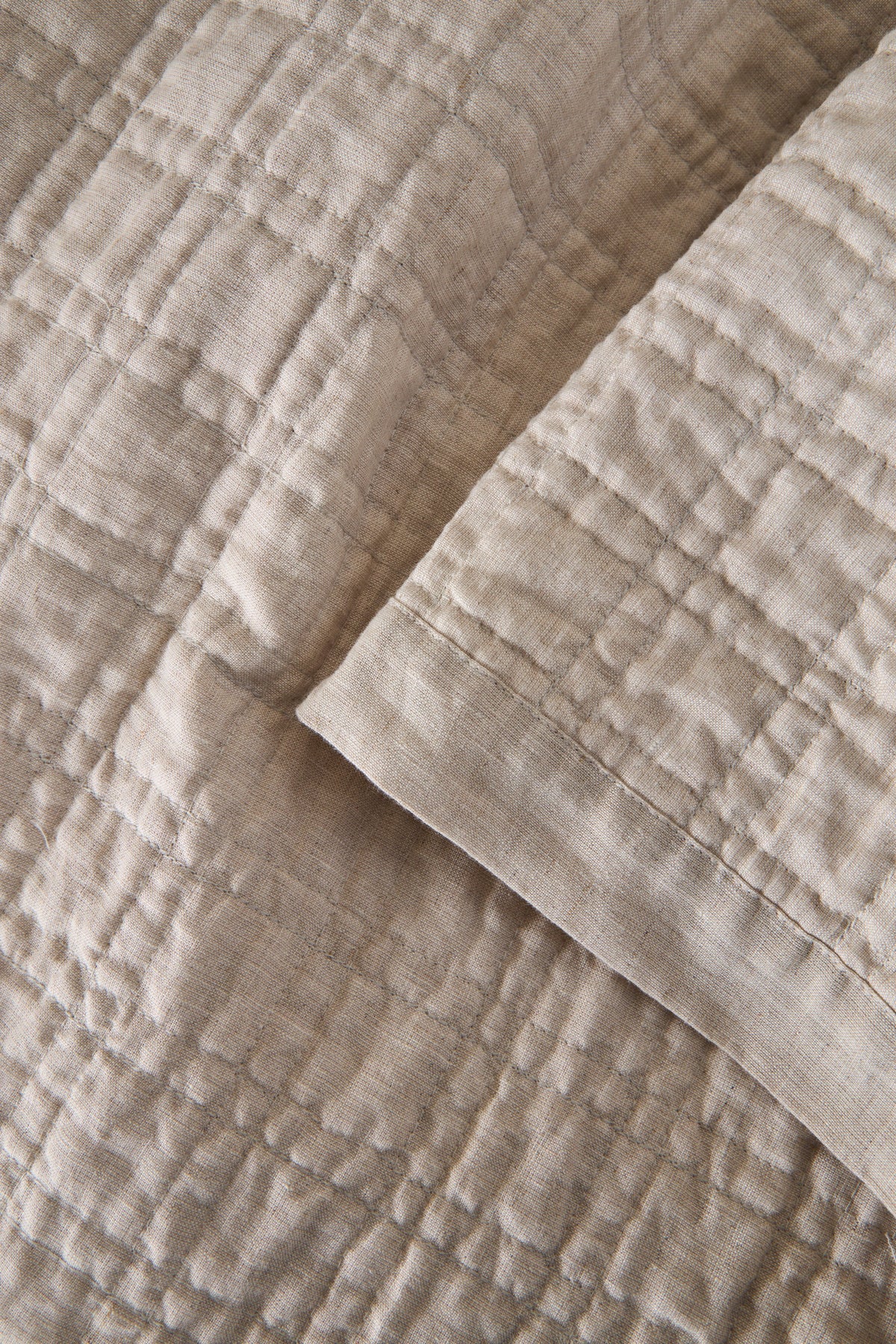 Owen coverlet close-up in light cream with stitched quilt texture