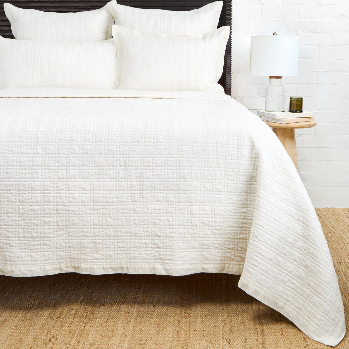 Owen quilted coverlet in white with textured stitched surface and matching shams