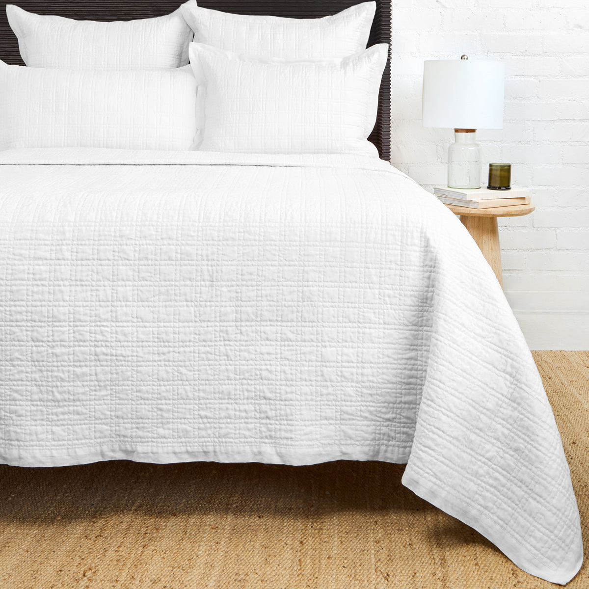 Owen quilted coverlet in white with textured paneling and neatly finished side
