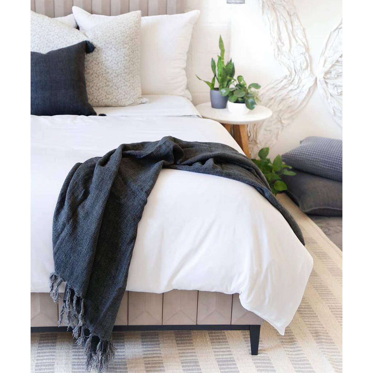 White bamboo sateen duvet set with pillow shams and a dark throw blanket