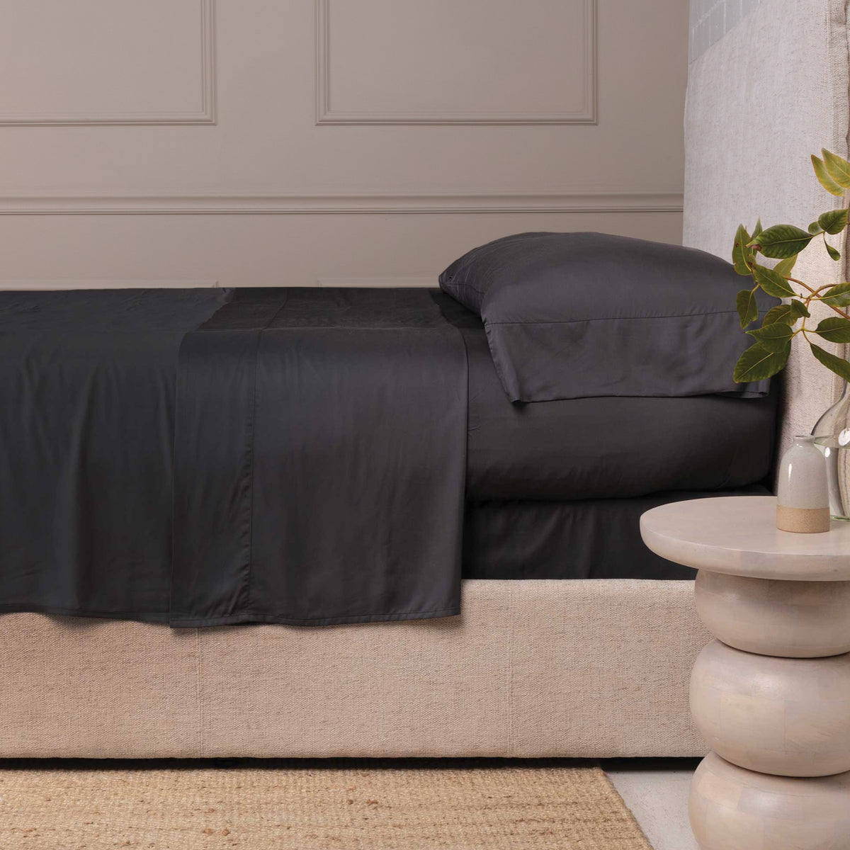 Sheet set in midnight, fitted and flat sheets with dark pillowcases on bed