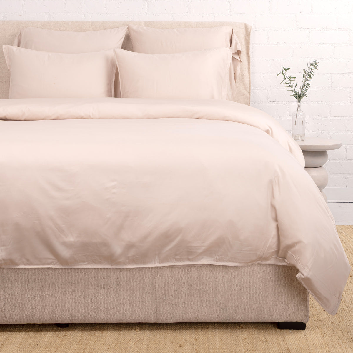 Ivory bamboo sateen duvet set with multiple pillow shams and folded corner