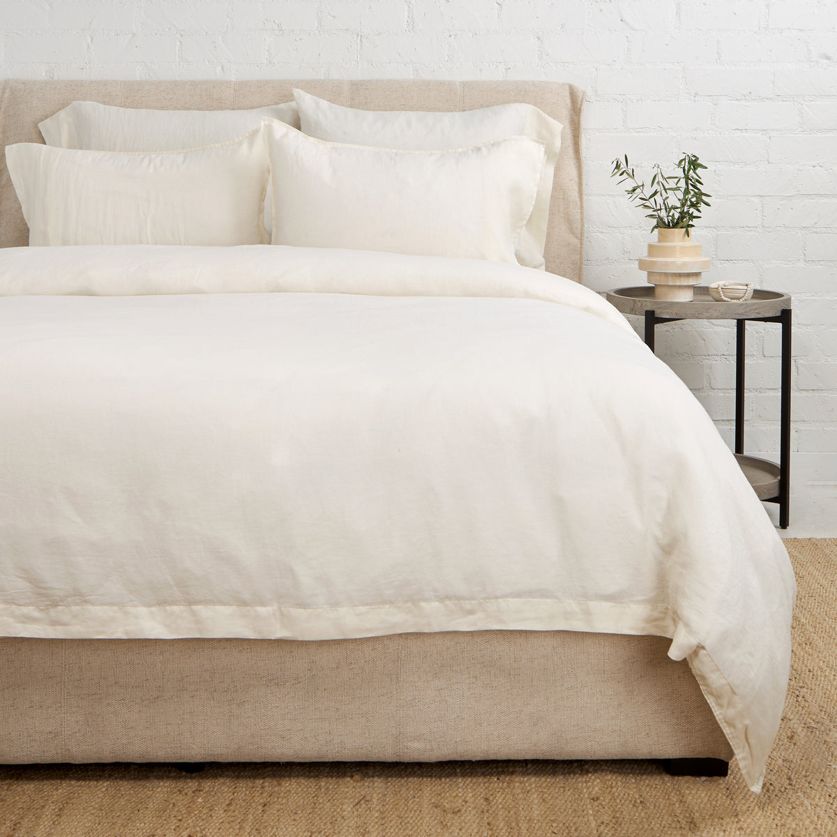 Cream linen duvet set with matching pillows, neatly fitted on a bed