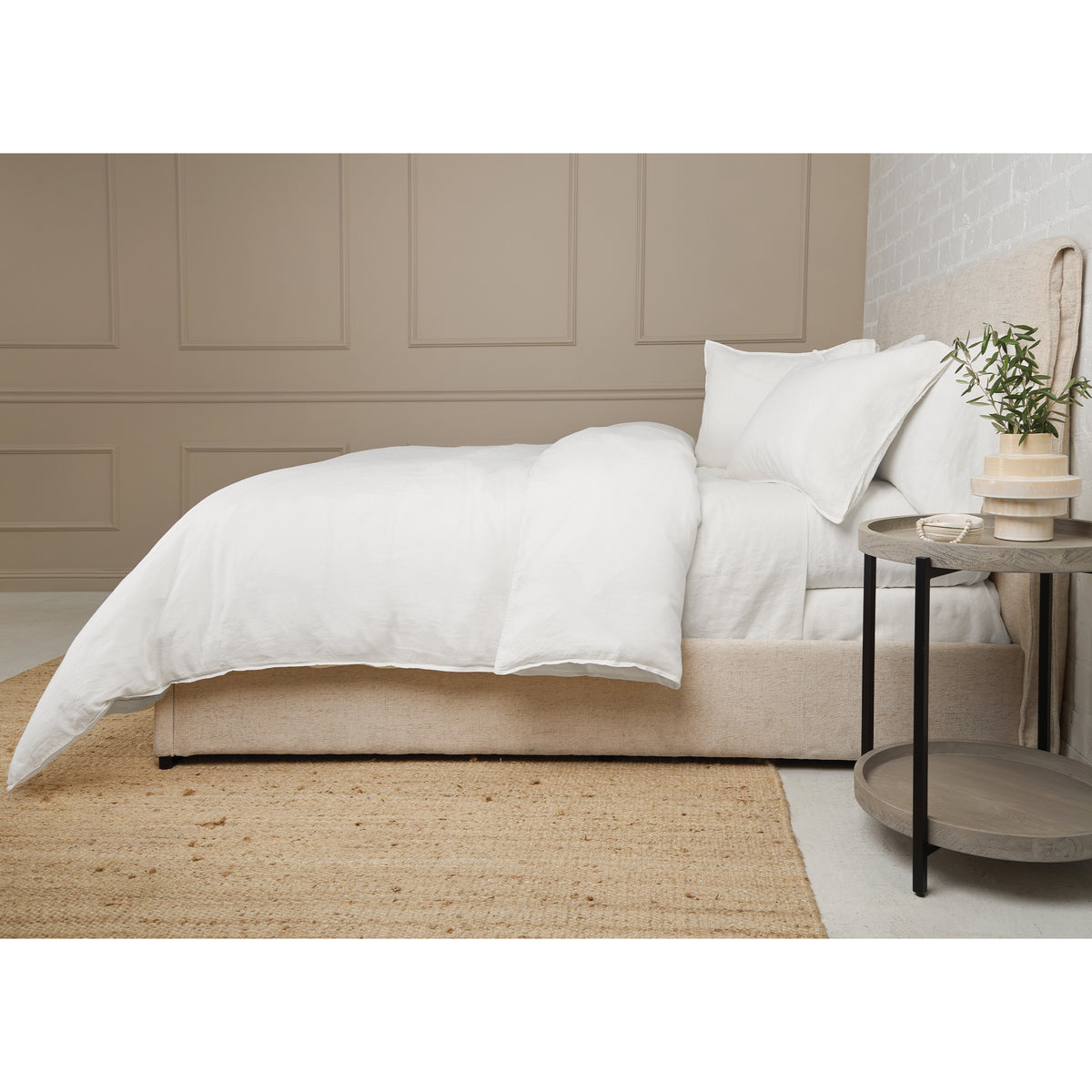 White linen duvet set with two pillows and duvet on a bed