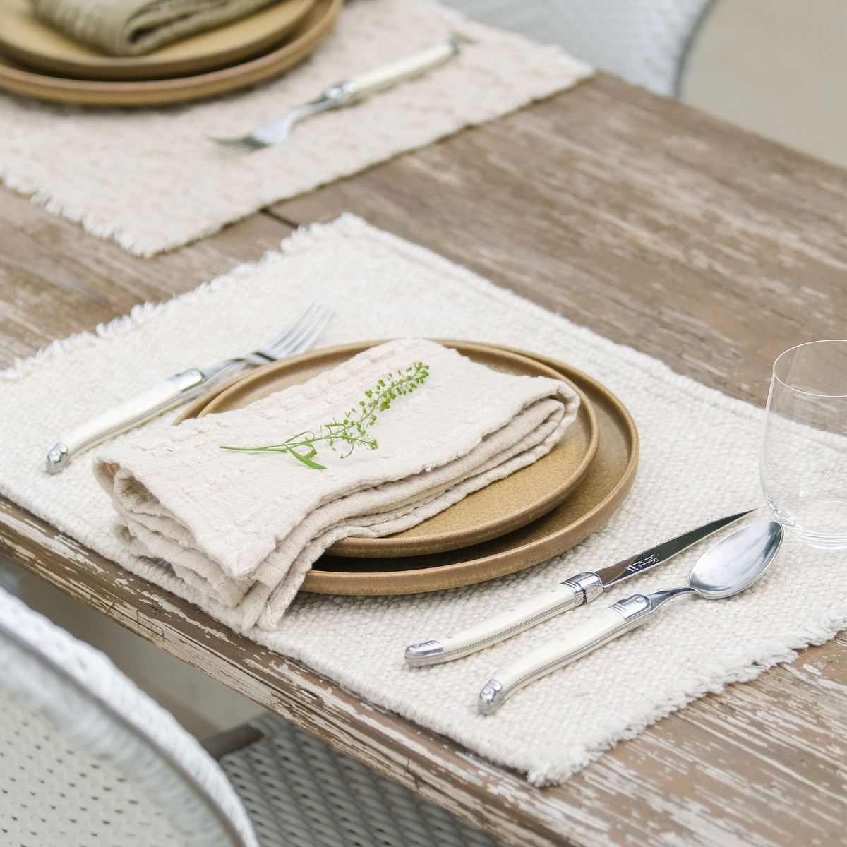 Natural beige placemat with fringed edges and woven texture