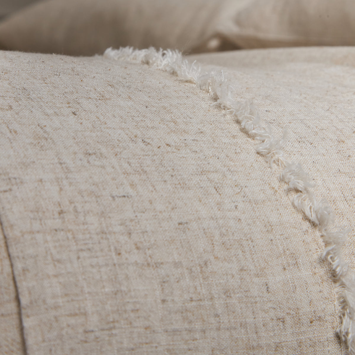 Natural bamboo linen sheet fabric close-up with woven texture and fringe