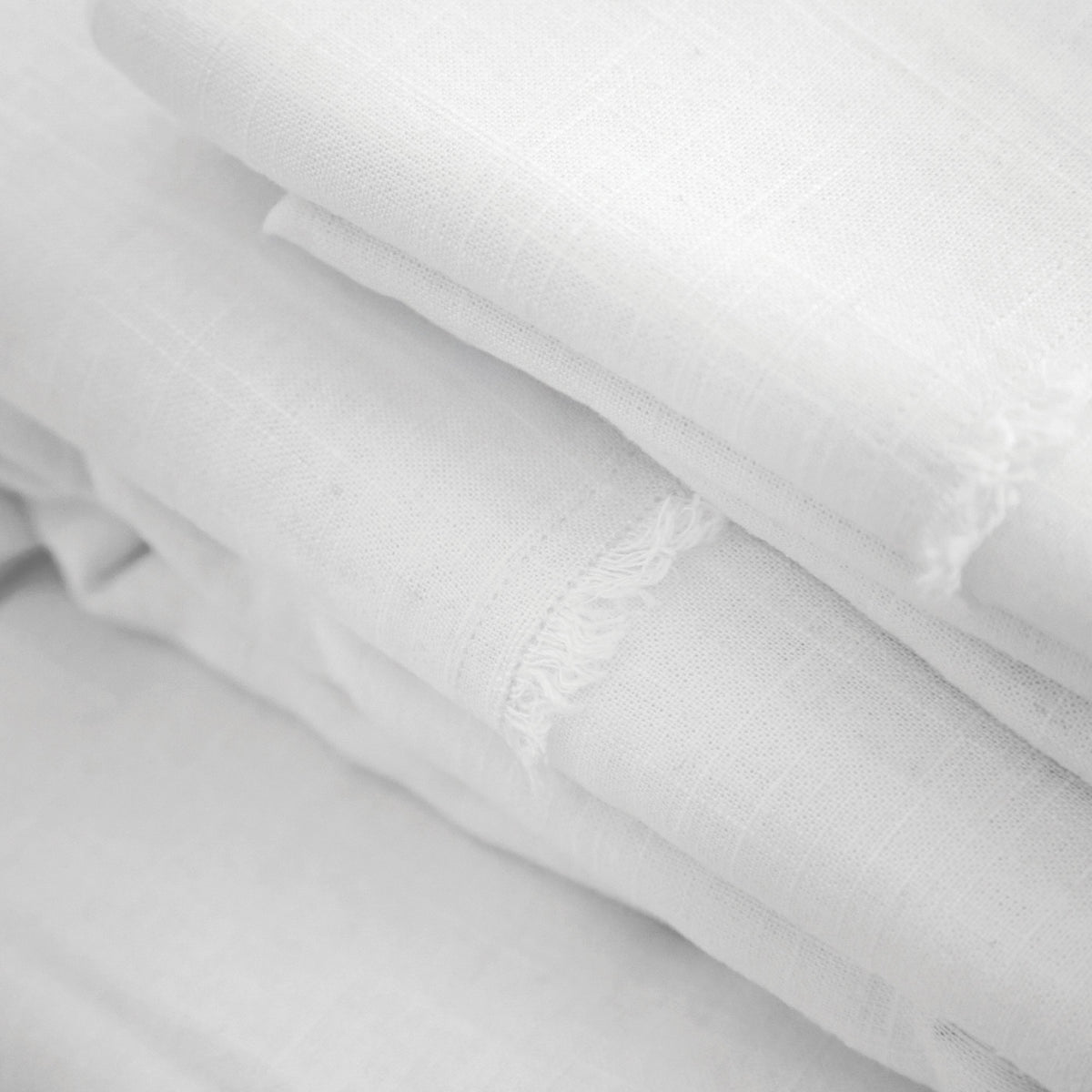 White bamboo linen sheet fabric close-up with textured weave