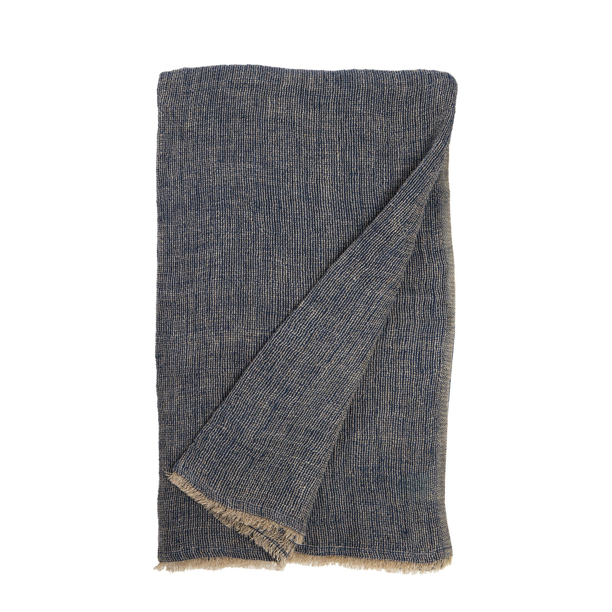 Dark navy oversized knit throw blanket with diagonal fold and fringed hem on a white background.