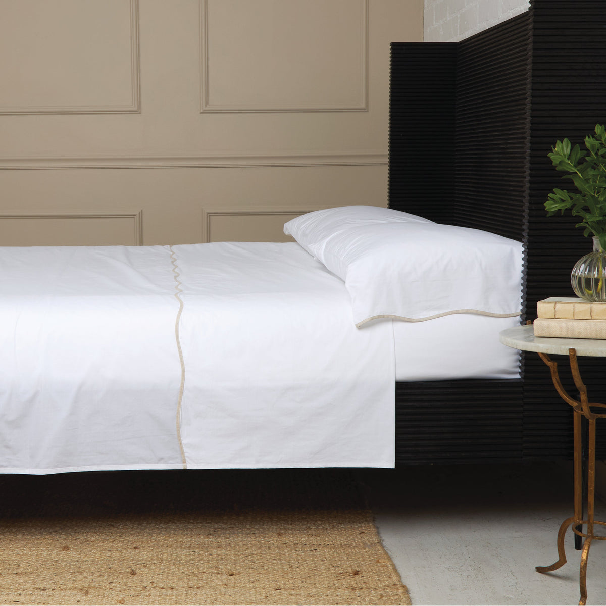 White cotton percale sheet set with subtle beige piping and standard pillow