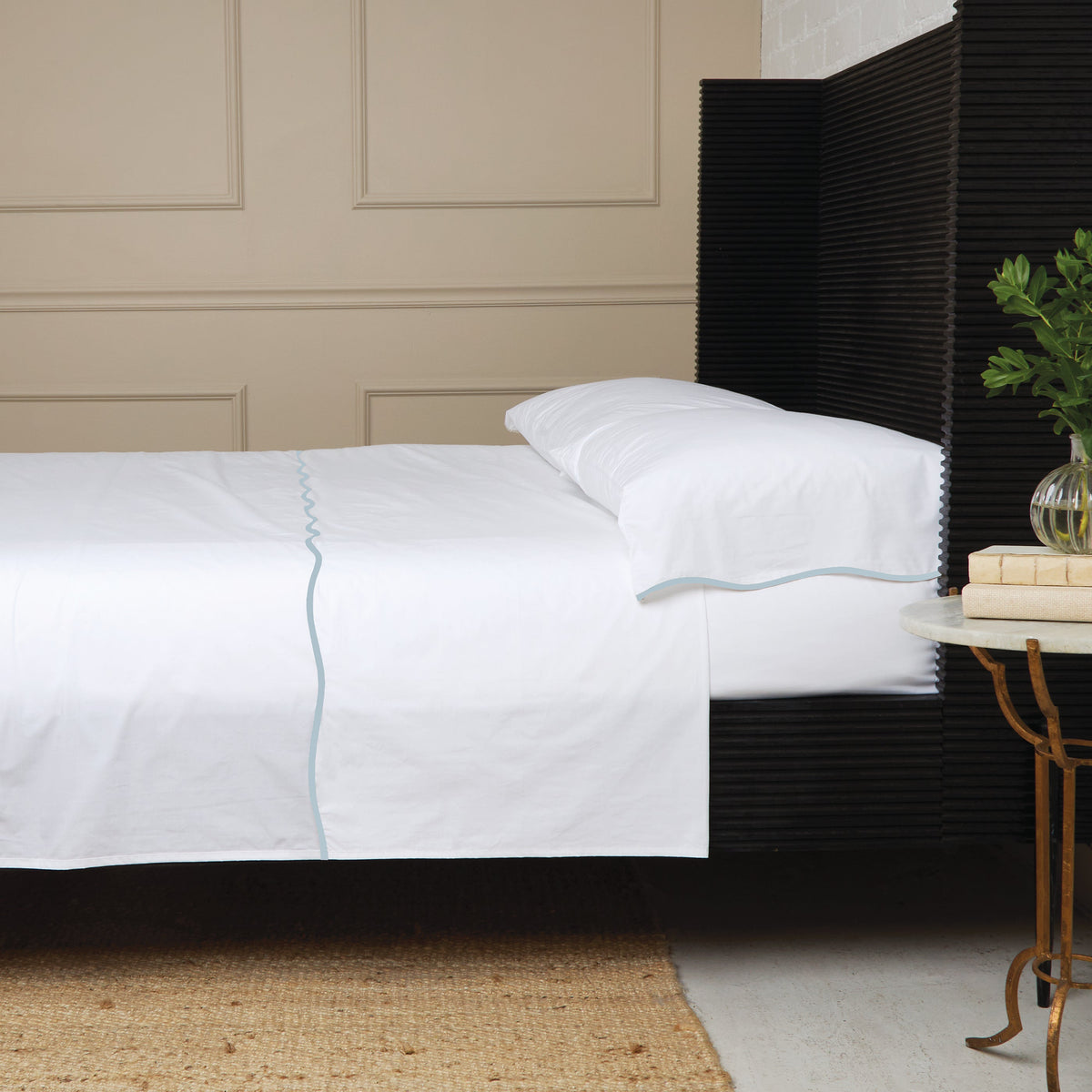 White cotton percale sheet set with light blue piping and standard pillow