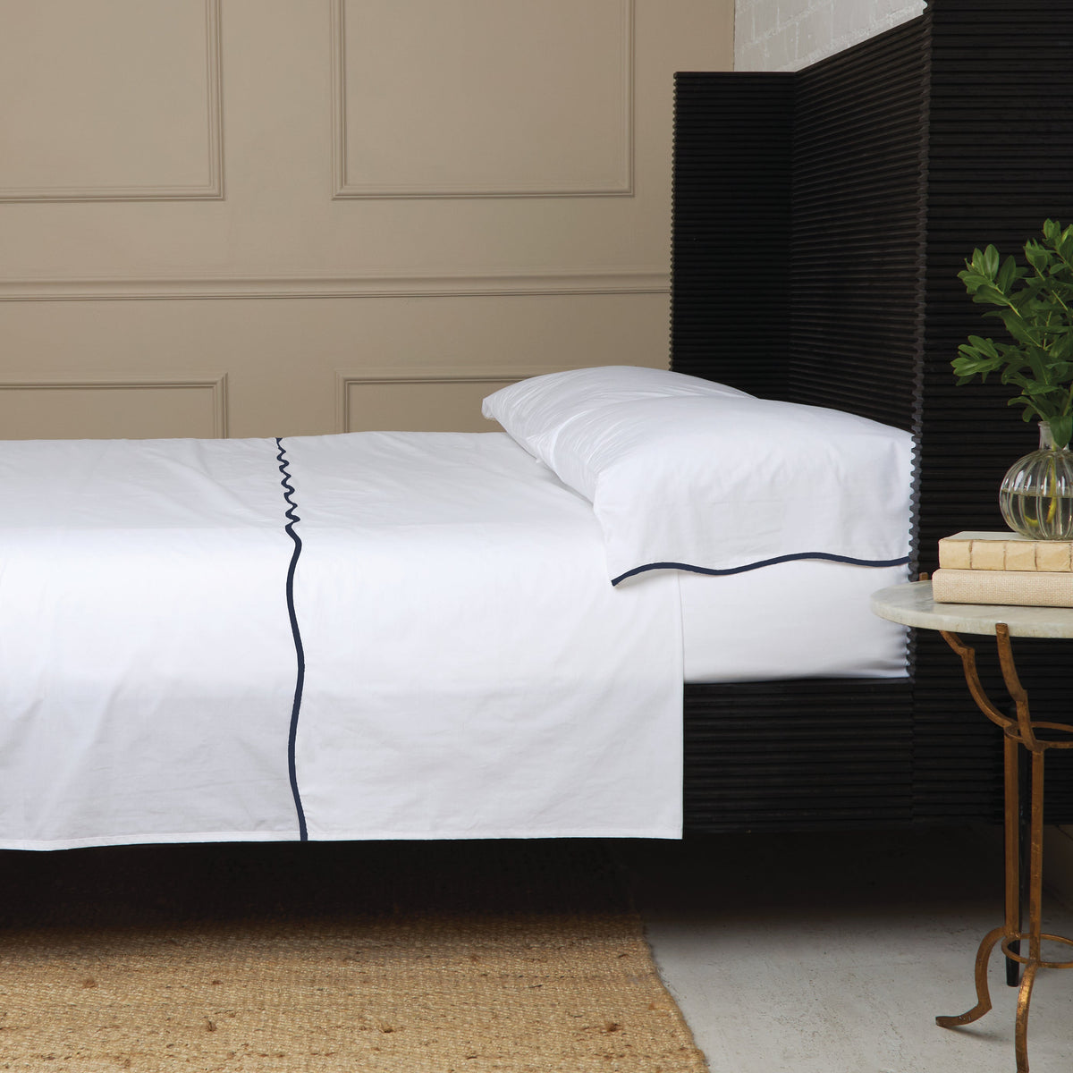 White cotton percale sheet set with navy piping and standard pillowcase