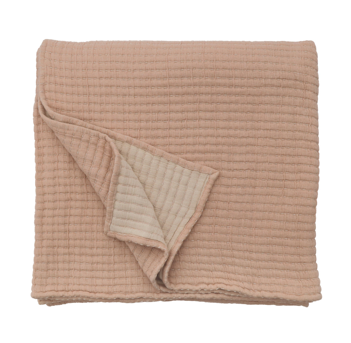 Oversized throw in amber with folded corner showing quilted waffle texture