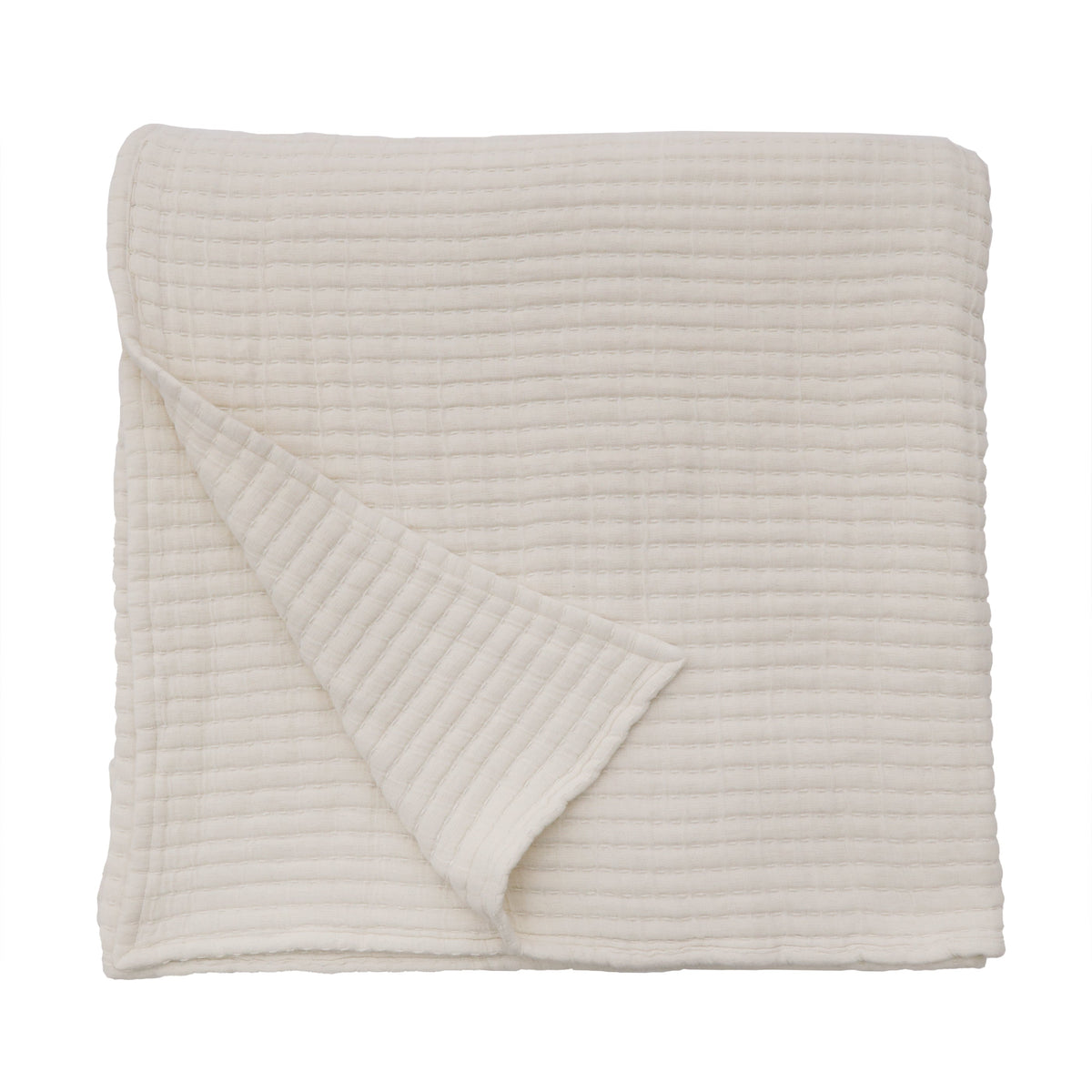 Vancouver coverlet folded in cream, quilted with looped stitch texture