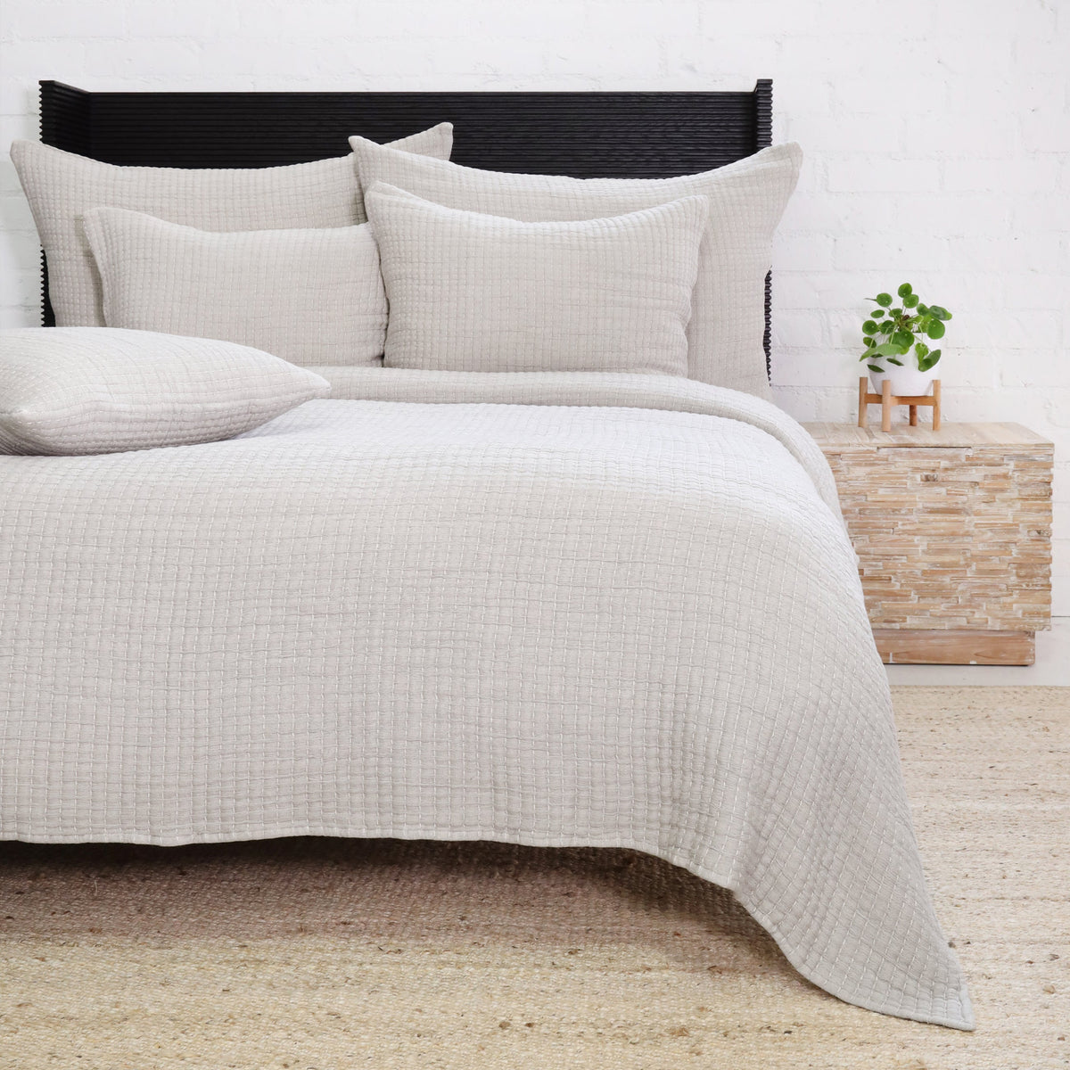 Light gray textured coverlet set with layered pillows