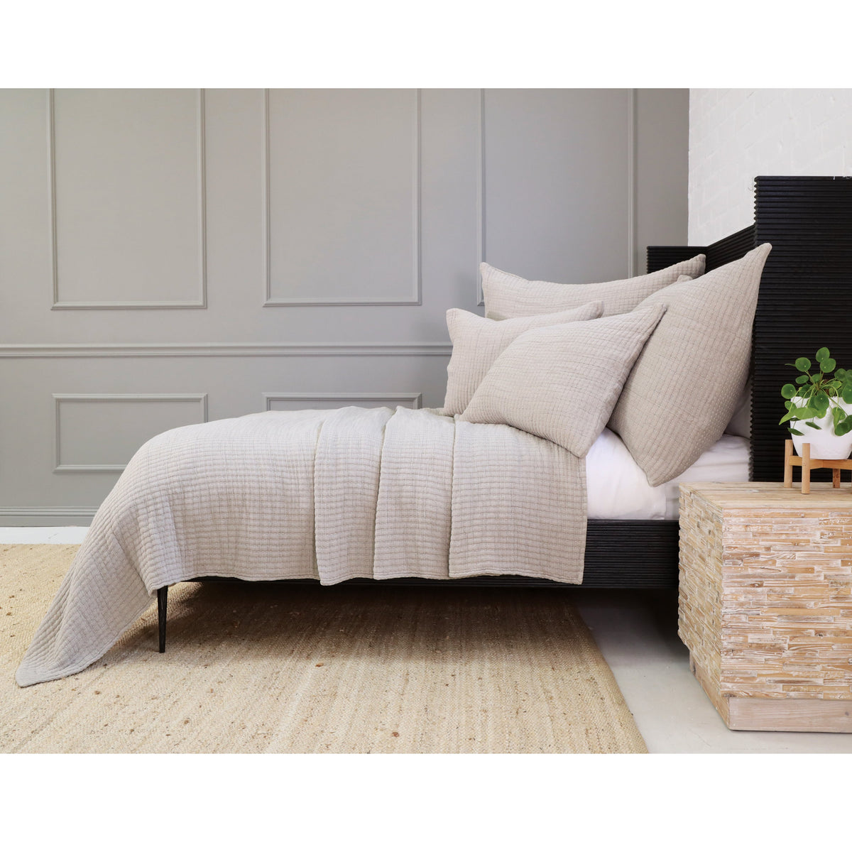 Cream textured coverlet set with pillows and folded coverlet edge