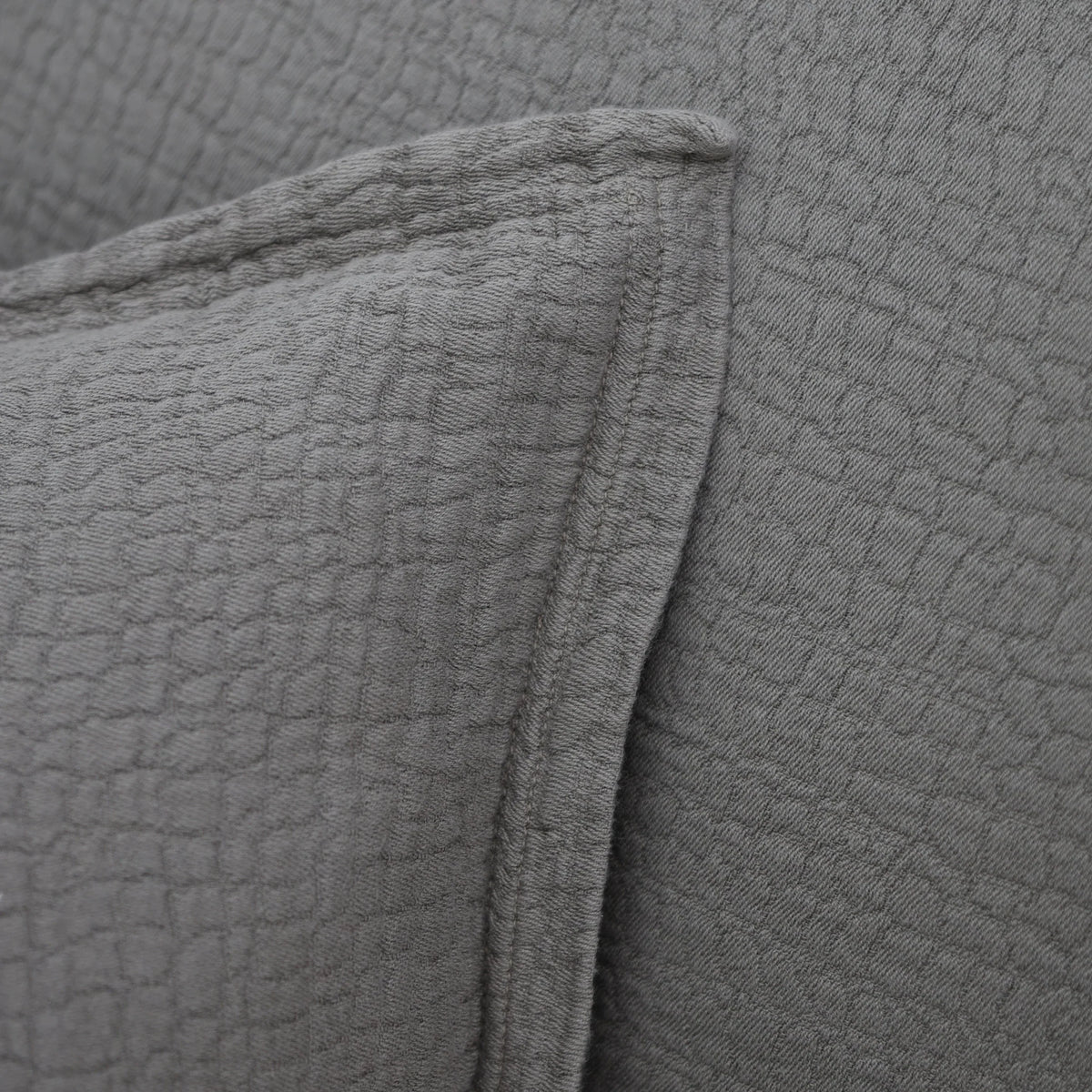 Gray quilted cotton fabric with textured square pattern