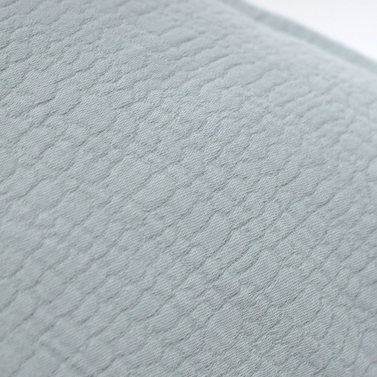 Light blue quilted cotton fabric with textured square pattern