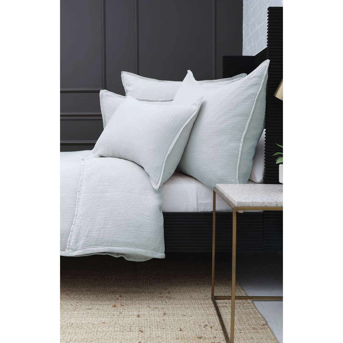 Stacked rectangular throw pillows with inserts, light blue cover detail