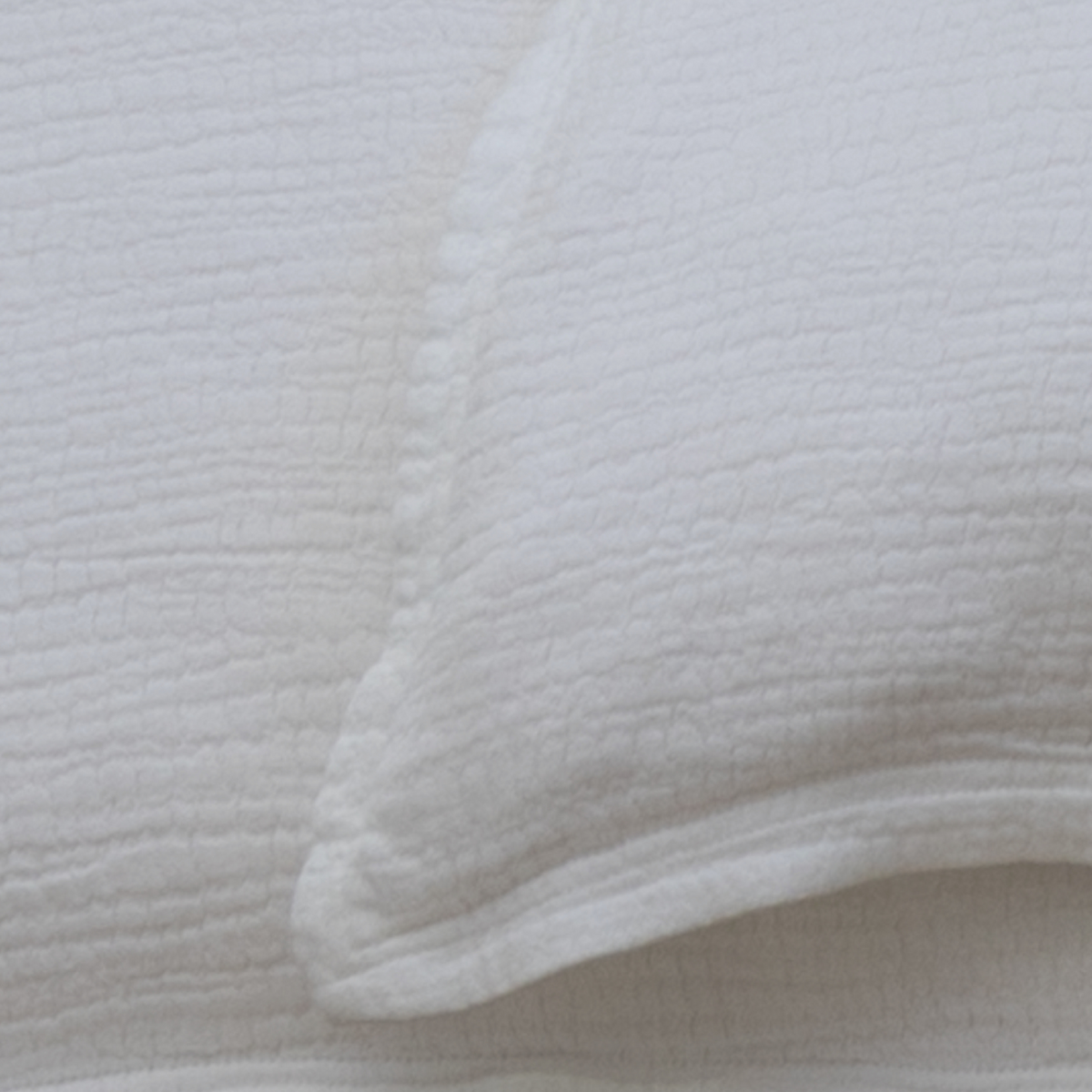 White cotton duvet cover fabric with subtle quilted square texture and hem