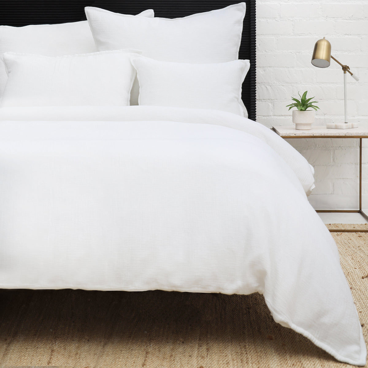White cotton duvet cover set with quilted square texture and matching standard shams